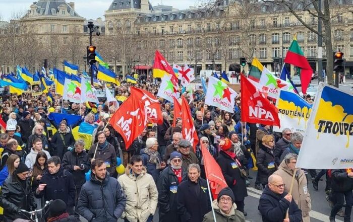 Drapeaux politiques et de pays de l'Est solidaires derrière la banderole du RESU © E!