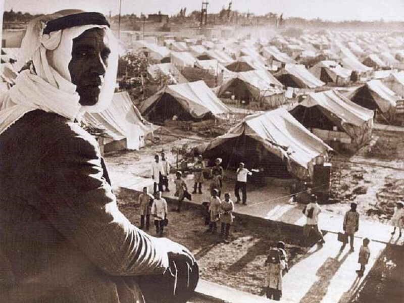Un homme regarde une école sous tentes après la Nakba